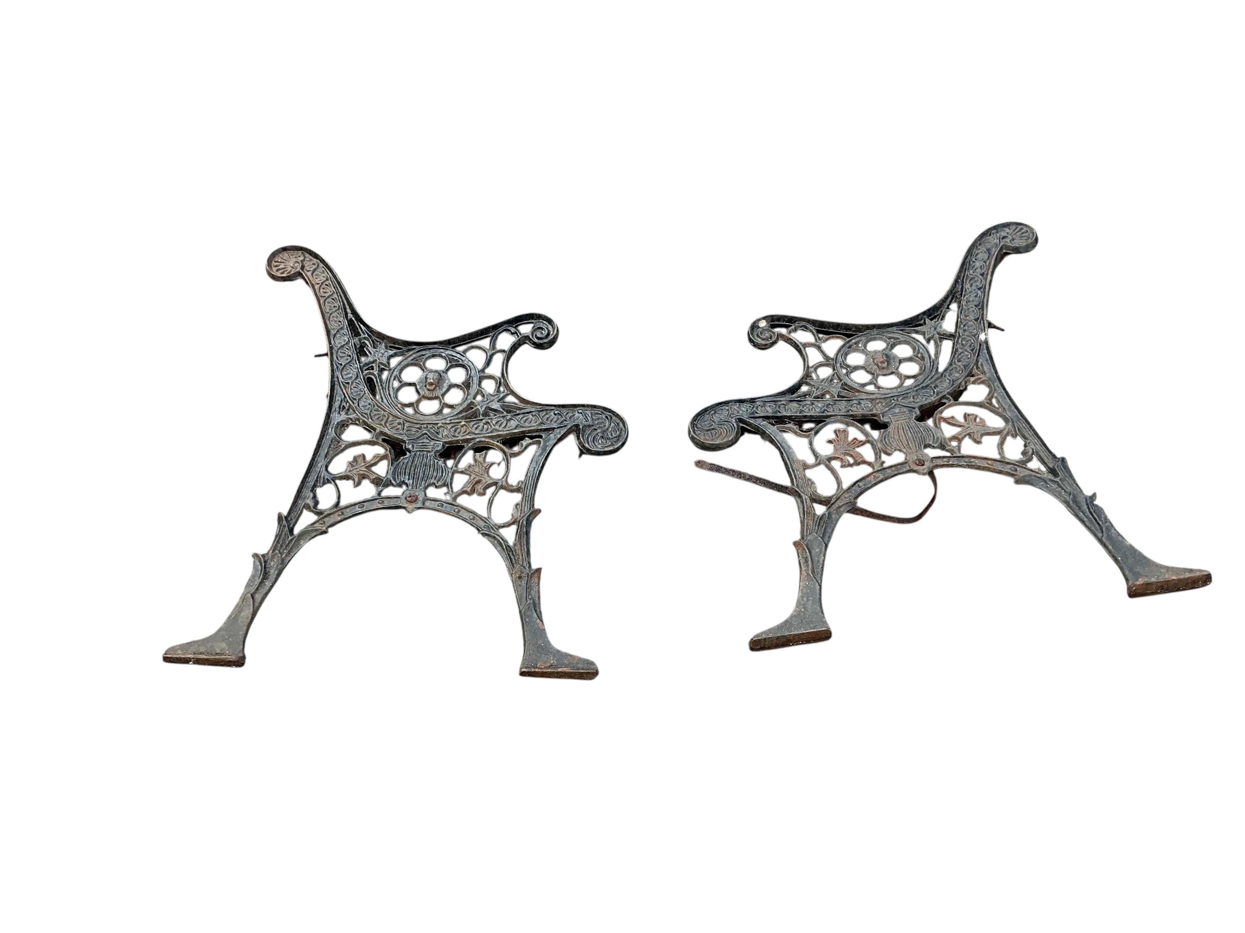 A painted metal garden easel together with two Victorian style cast metal bench ends